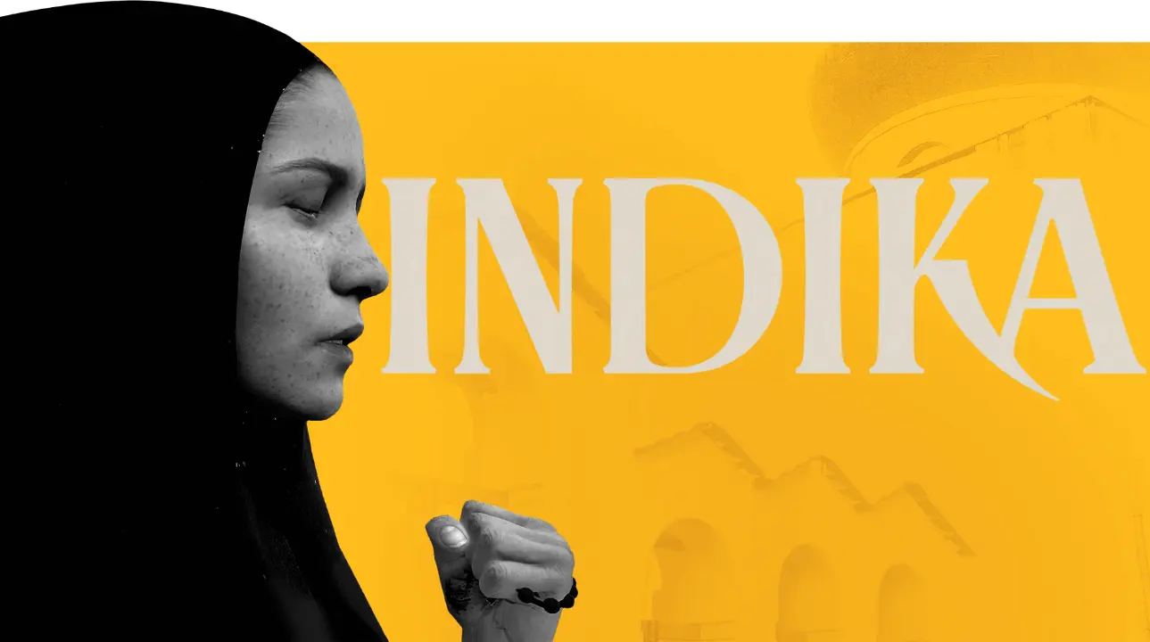 Nun in profile holding rosary, INDIKA title on yellow backdrop