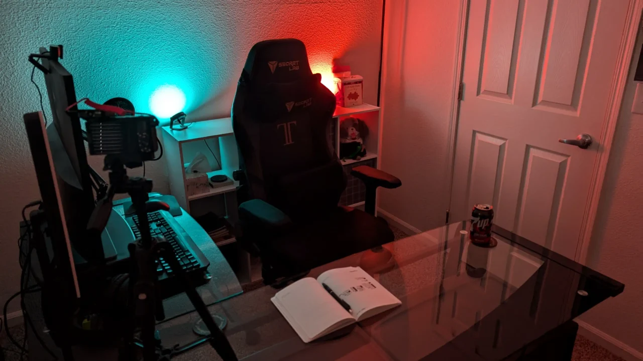 Joe Theis’ workstation with green ambient lighting, dual monitors, and PC setup.