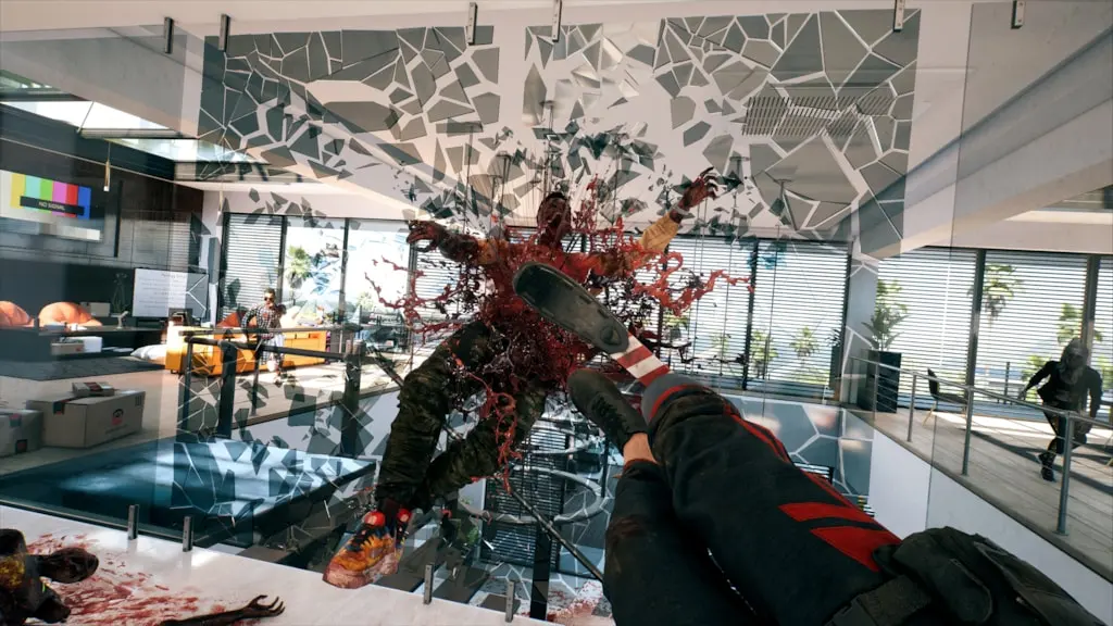 A player character kicks a bloodied zombie through a shattered glass wall in Dead Island 2’s SoLA DLC, causing an explosive blood splatter.