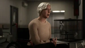 Elderly woman in wheelchair talking beside a caged bird