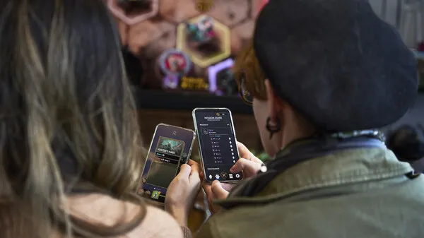 Two people playing games on their smartphone