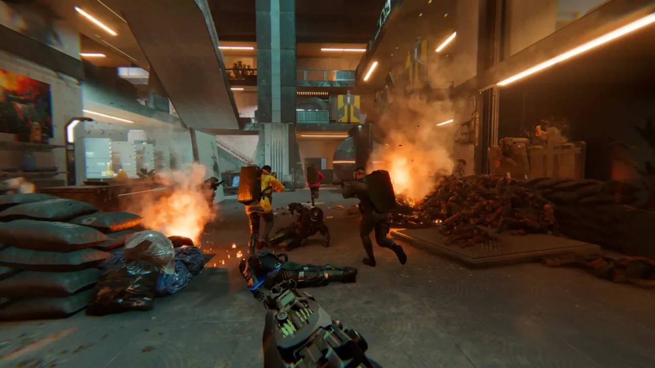 Den of Wolves screenshot—squad pushes through a burning futuristic atrium; first-person view.
