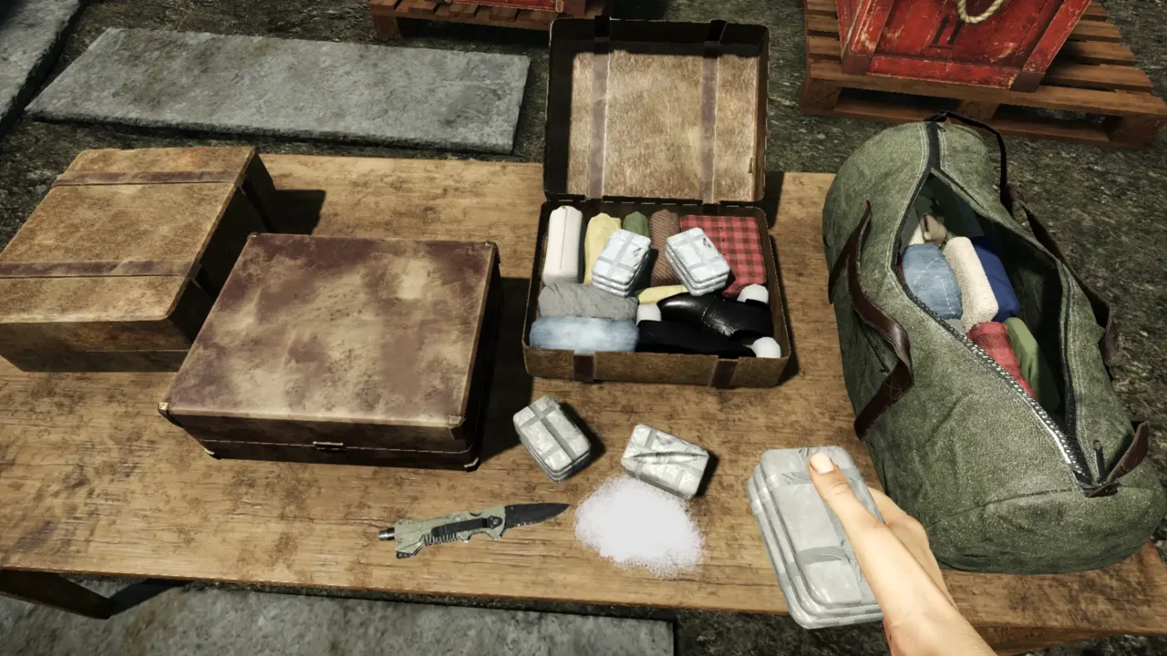 Open duffel and suitcase reveal clothing plus wrapped contraband bricks on an inspection table.