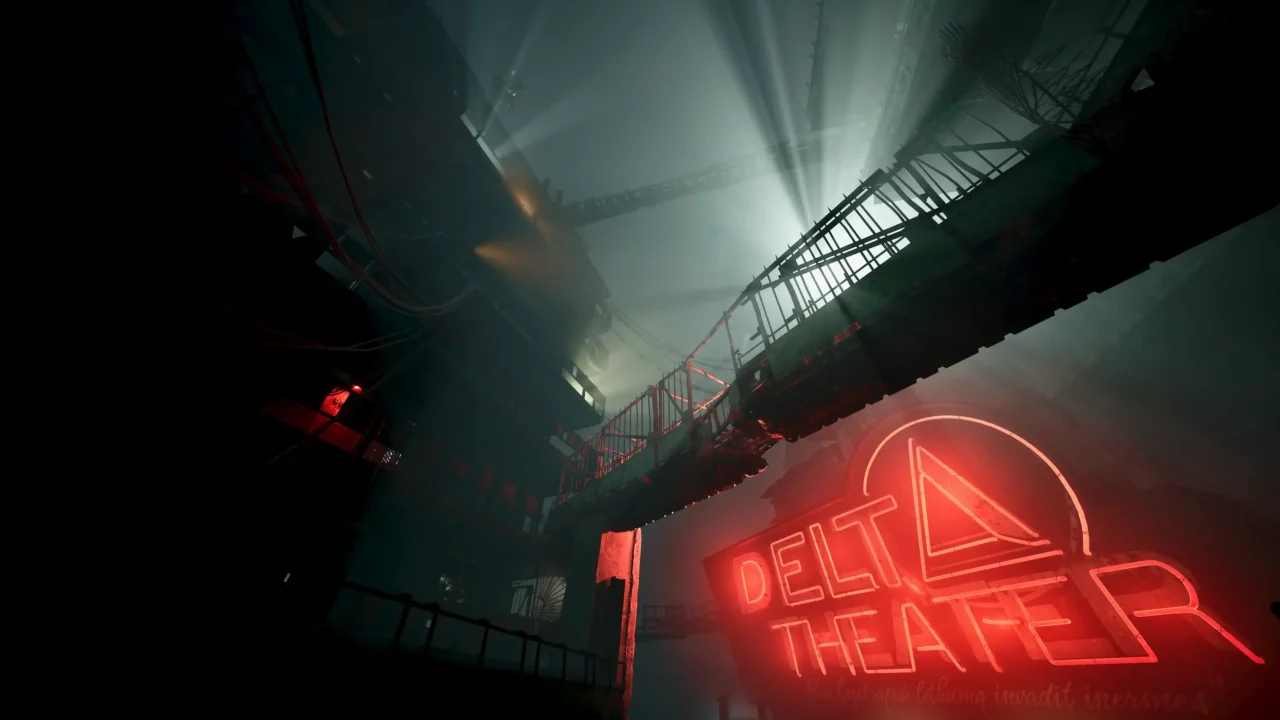 A towering industrial space viewed from below with catwalks and cables, with a large red neon sign reading “DELTA THEATER.”