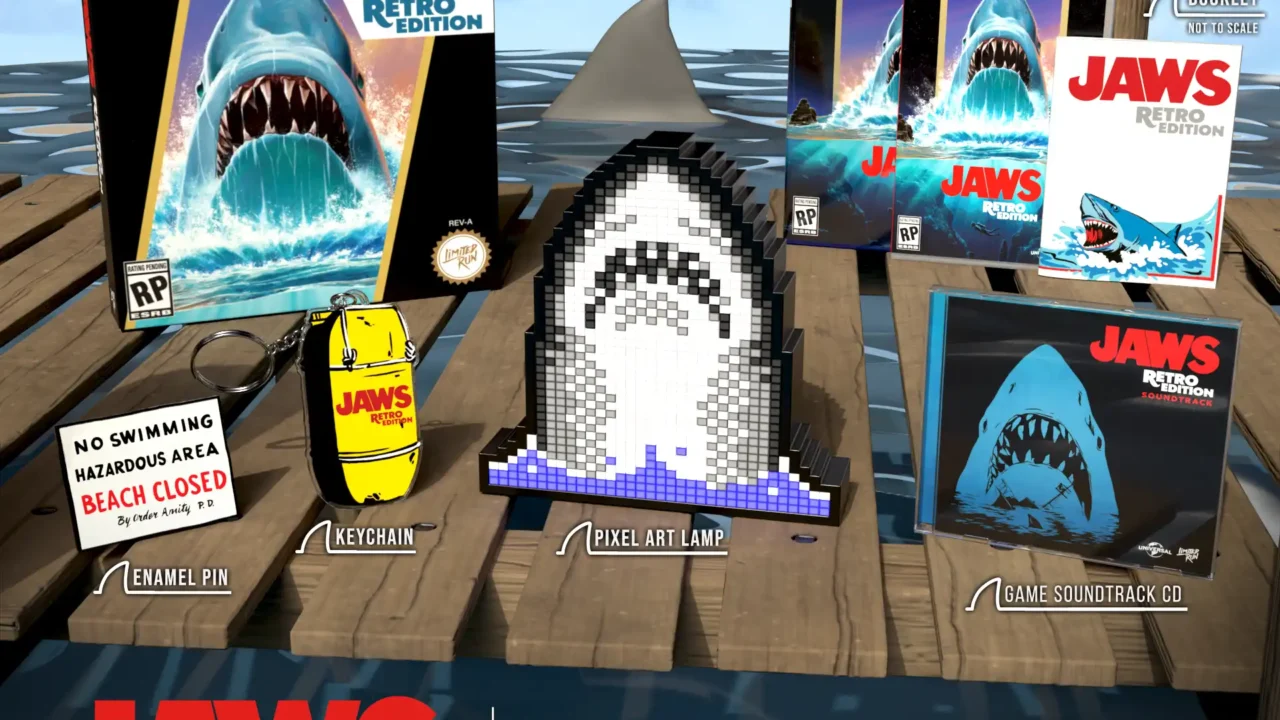 Jaws Retro Edition Bigger Boat Edition collector’s set with game box, enamel pin, keychain, pixel art shark lamp, and soundtrack CD for PS5 and Nintendo Switch.