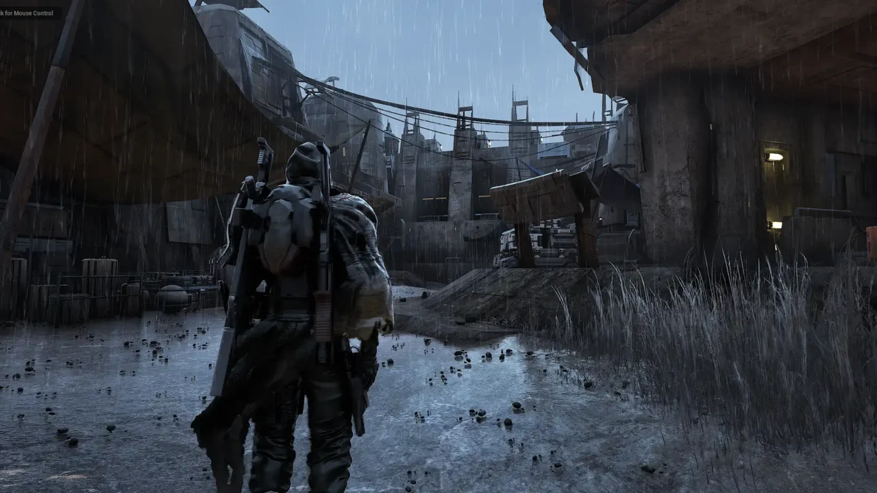 Riftwalker character standing in heavy rain inside a settlement area during the game’s weather system sequence