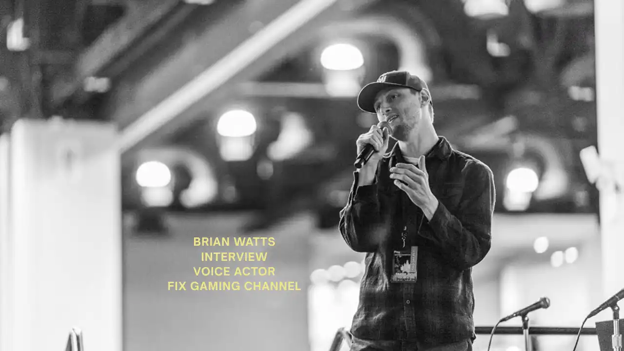 Brian Watts speaking into a microphone during a live event