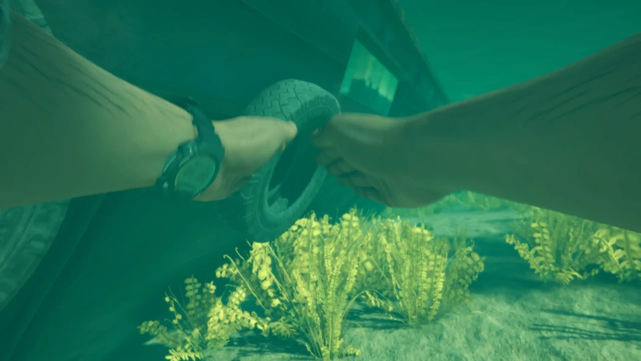 Stranded Deep 2 first-person underwater screenshot showing a survivor handling a tire near submerged wreckage