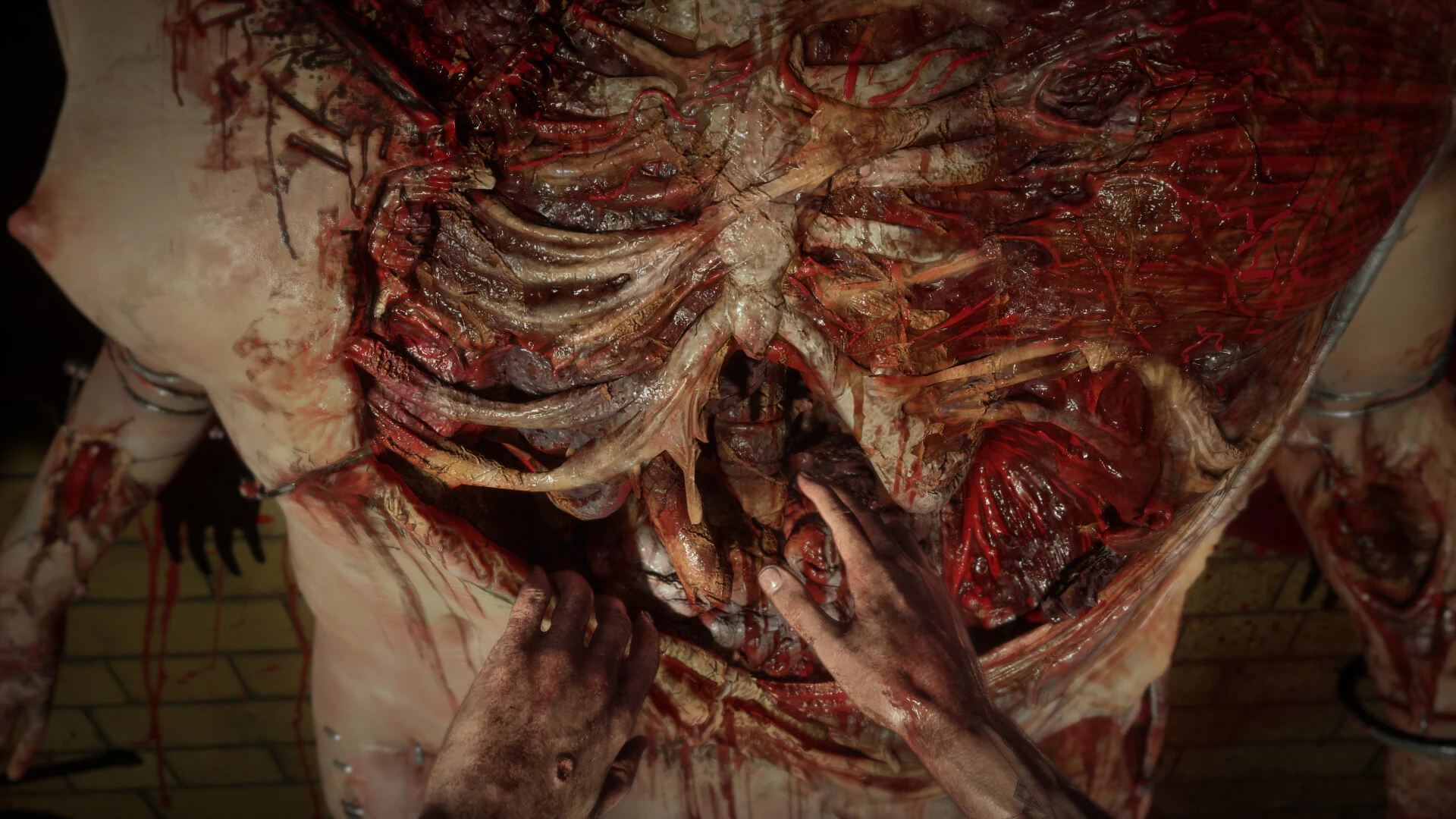 First-person close-up of hands pressing against an enormous grotesque mass of exposed flesh and bone in Hellraiser: Revival.