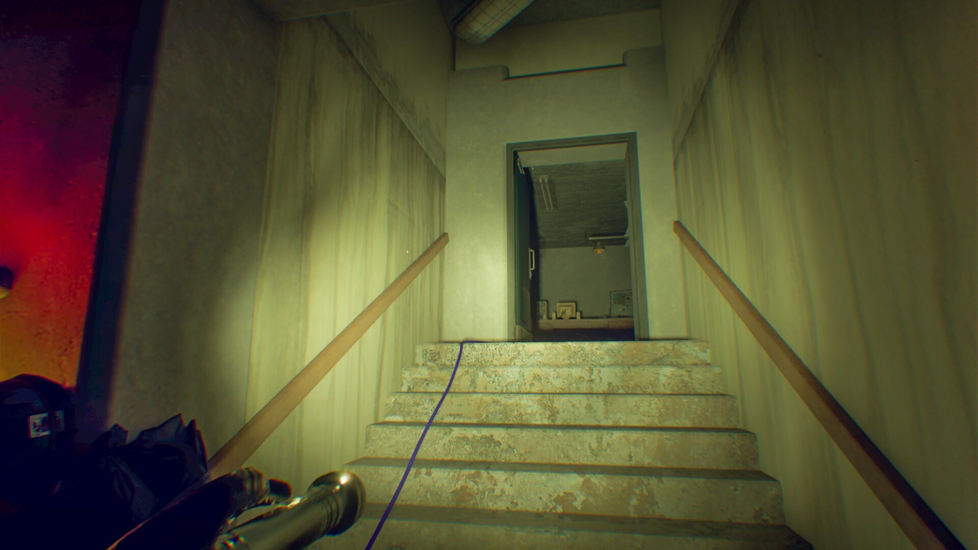 A narrow concrete staircase in Pestilence with a blue cable running up toward an open doorway.